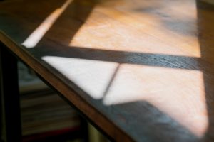 Sunshine on wood table with light and shadow